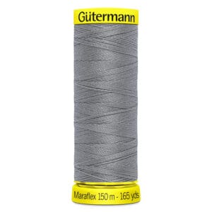 A spool of Gütermann Maraflex thread in gray, showing its brand and length details. The spool is yellow on the top and bottom, marked with "Gütermann" on top and "Maraflex 150 m - 165 yds" at the bottom.