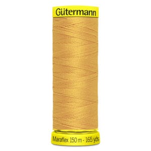 A spool of Gütermann Maraflex yellow thread. The spool is cylindrical, with yellow labels at the top and bottom. Text on the bottom label reads "Maraflex 150 m - 165 yds.