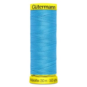A spool of Gütermann Maraflex thread in bright blue, labeled with 150 meters and 165 yards. The top and bottom of the spool are yellow.