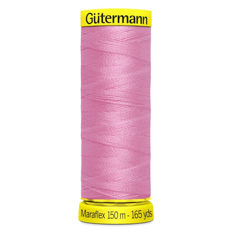 A spool of Gütermann Maraflex thread in pink, labeled as 150 meters (165 yards). The spool has yellow ends with black text showing the brand and thread details.