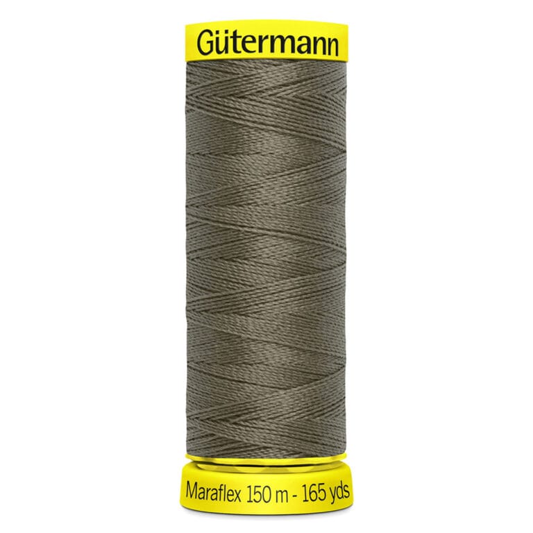 A spool of Gütermann MaraFlex thread in dark green. The spool has a yellow top and bottom, with labeling that reads "Gütermann" and "Maraflex 150 m - 165 yds.