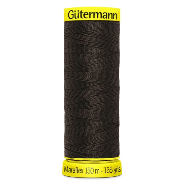 A spool of Gütermann Maraflex elastic thread in dark color, labeled with 150 meters and 165 yards, with bright yellow caps at the top and bottom.