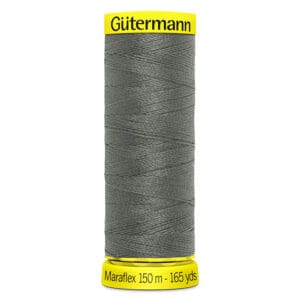 A spool of Gütermann thread labeled "Maraflex 150 m - 165 yds" in dark gray. The spool has bright yellow caps at the top and bottom.
