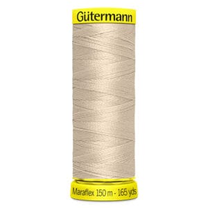 A spool of Gutermann Maraflex thread is shown, wrapped with light beige thread. The top is labeled "Gutermann" in black on a yellow background, and the bottom indicates "Maraflex 150 m - 165 yds.