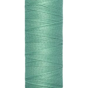 A spool of Gütermann sewing thread, light teal in color, labeled as 100 meters (110 yards) in length. The spool has a cream-colored base and top with brand name on top.