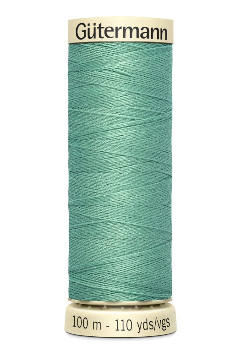 A spool of Gütermann sewing thread, light teal in color, labeled as 100 meters (110 yards) in length. The spool has a cream-colored base and top with brand name on top.