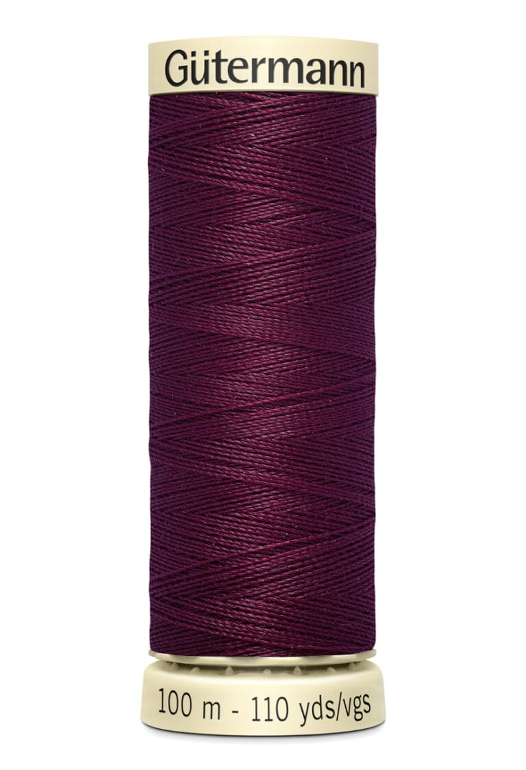 A spool of Gütermann thread in deep purple. The label indicates 100 meters (110 yards) of thread. The spool is beige, with the brand name printed at the top.