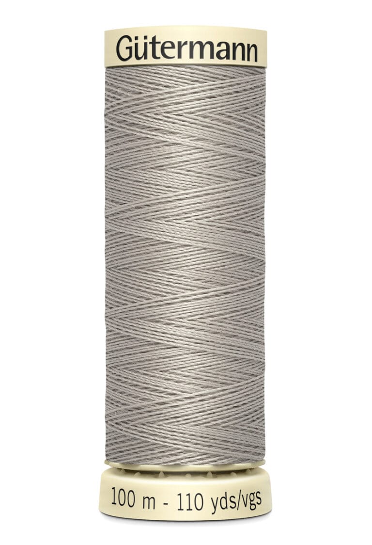 A spool of gray Gütermann sewing thread, labeled with "100 m - 110 yds/vgs" on the base. The spool has a beige top and bottom.