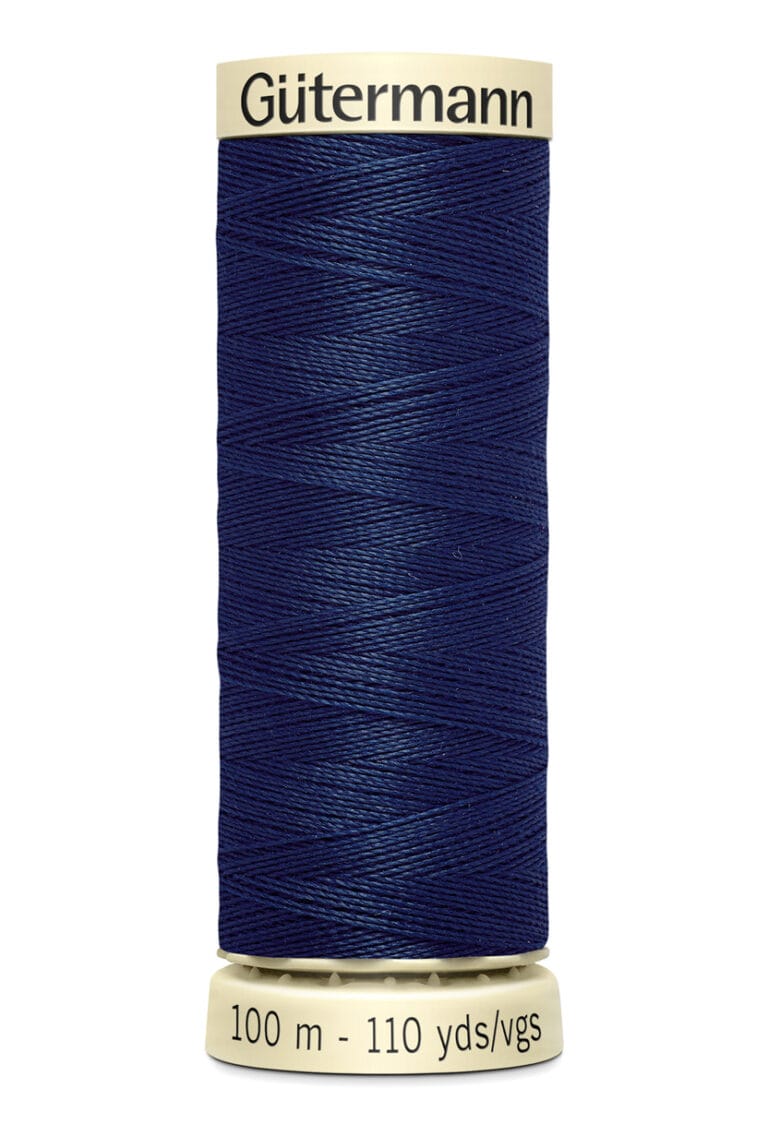 A spool of Gütermann thread in dark blue color, featuring a label displaying "100 m - 110 yds/vgs" at the base. The thread is neatly wound around the spool.