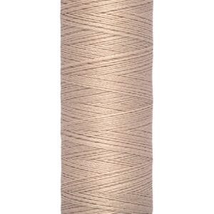A spool of Gütermann thread in a light brown color, designed for sewing. It has a label at the top and bottom indicating "100 m - 110 yds/vgs.