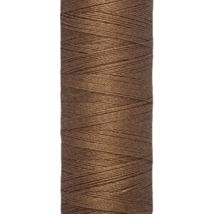 Spool of Gütermann brown sewing thread, labeled with 100 meters and 110 yards, featuring a creamy beige top and bottom lid.