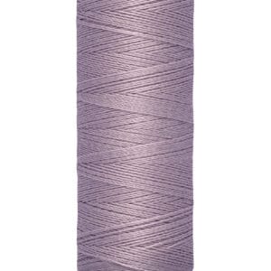 Spool of Gutermann thread, labeled "100 m - 110 yds/vgs," in a light purple color. The spool has cream-colored ends with the brand name printed on the top.