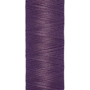 A spool of Gütermann thread in deep purple color, labeled at the bottom with "100m - 110 yds/vgs." The spool is cylindrical with a cream-colored top and bottom.