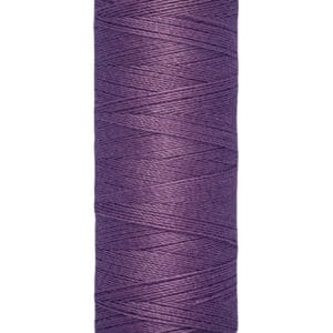 A spool of Gütermann sewing thread in deep purple. The label shows the thread is 100 meters or 110 yards long.