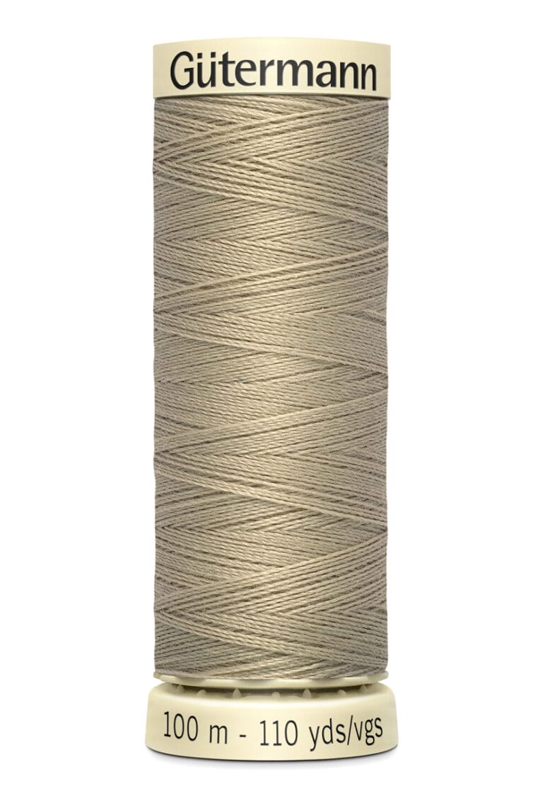 A spool of Gütermann sewing thread in light beige is shown. The spool is labeled with "100 m - 110 yds" and "Gütermann" at the top. The thread is neatly wound around the spool.