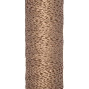 Spool of brown Gütermann sewing thread with labels showing length as 100 meters or 110 yards.
