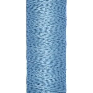 A spool of Gütermann thread in light blue, featuring a visible label with the brand name on top. The thread is tightly wound around the spool, which indicates the length of 100 meters or 110 yards at the bottom.
