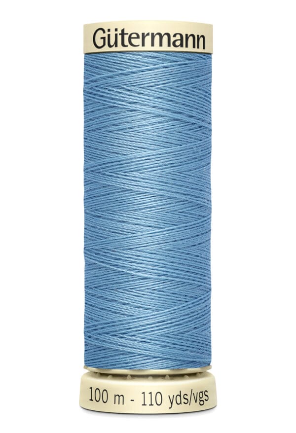 A spool of Gütermann thread in light blue, featuring a visible label with the brand name on top. The thread is tightly wound around the spool, which indicates the length of 100 meters or 110 yards at the bottom.