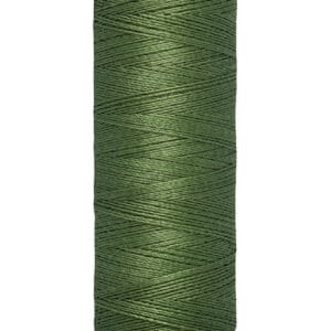 A spool of Gütermann green sewing thread, wrapped neatly around a beige plastic spool. The label indicates 100 meters or 110 yards/vgs.