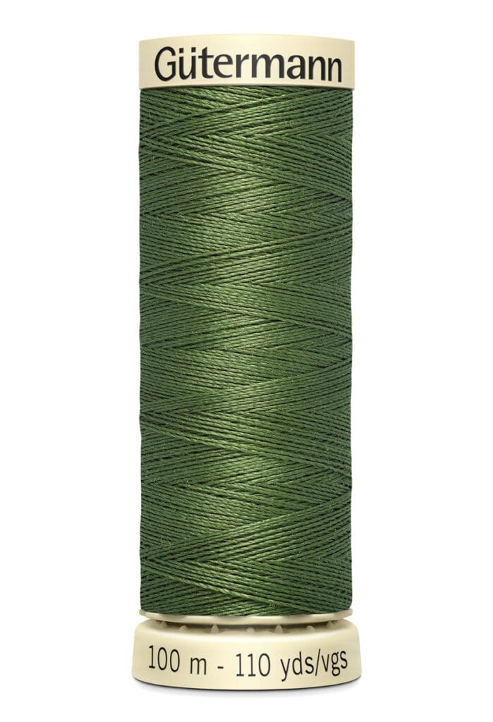 A spool of Gütermann green sewing thread, wrapped neatly around a beige plastic spool. The label indicates 100 meters or 110 yards/vgs.