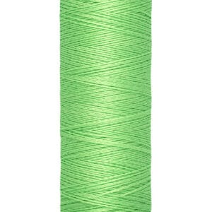 A spool of Gütermann polyester thread in bright green. The spool indicates a length of 100 meters or 110 yards.