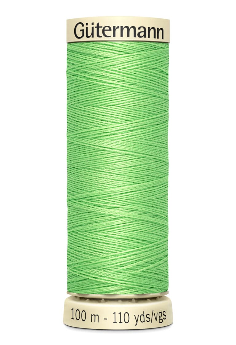 A spool of Gütermann polyester thread in bright green. The spool indicates a length of 100 meters or 110 yards.