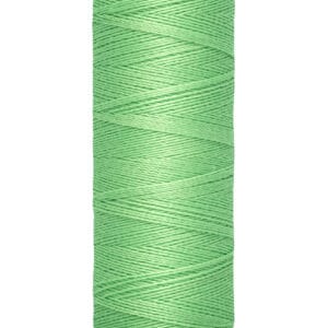A spool of Gütermann thread with light green thread, labeled as 100 meters or 110 yards.