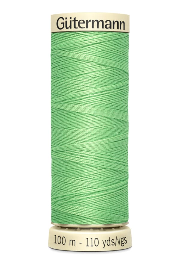 A spool of Gütermann thread with light green thread, labeled as 100 meters or 110 yards.