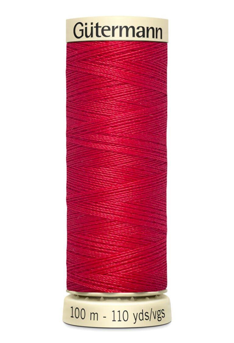 A spool of Gütermann sewing thread in vibrant red, with a label indicating 100 meters or 110 yards. The spool is cylindrical with cream-colored ends featuring the brand name at the top.