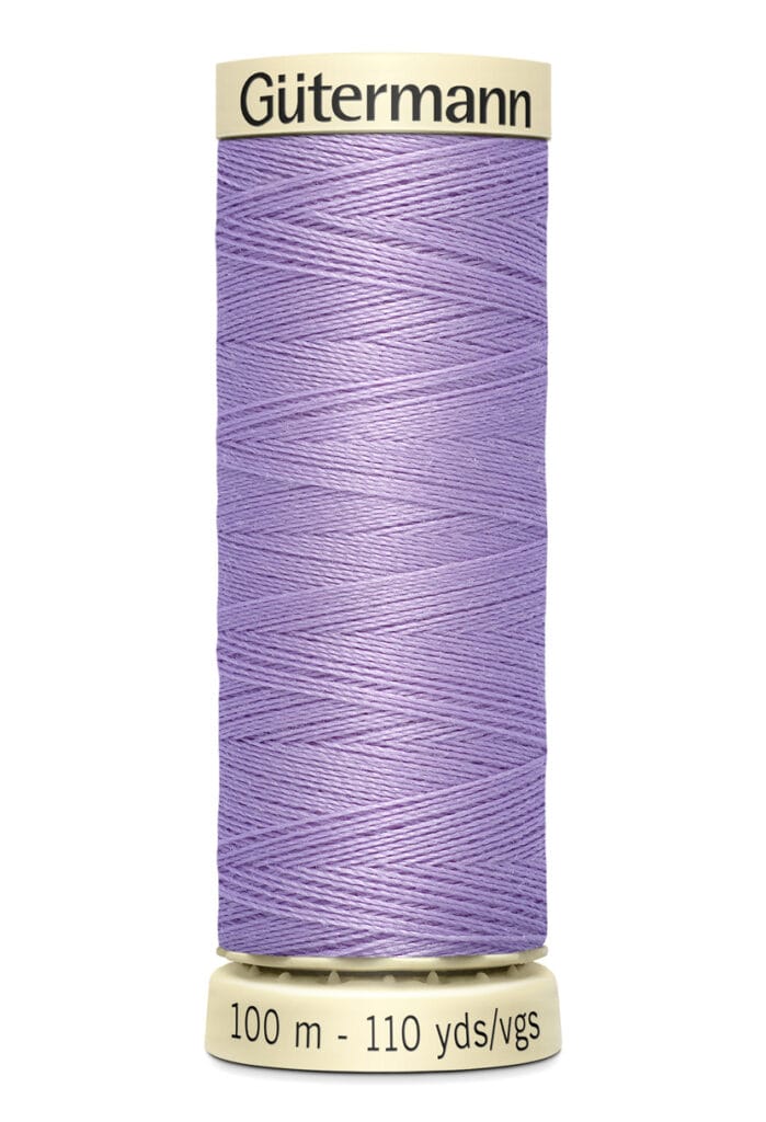 A spool of Gütermann thread with 100 meters (110 yards) of light purple thread. The spool has a cream-colored top and base, displaying the brand name and length details.