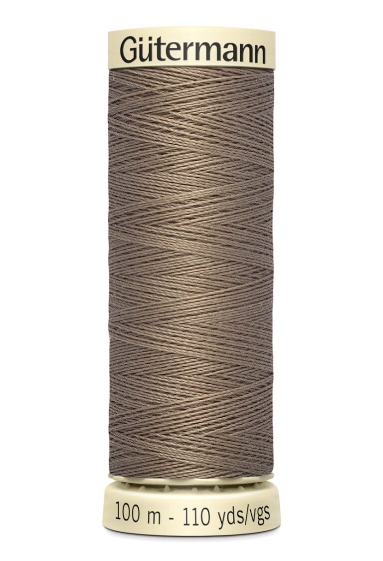 A spool of Gütermann sewing thread in a taupe color, labeled with "100 m - 110 yds/vgs" on the bottom.