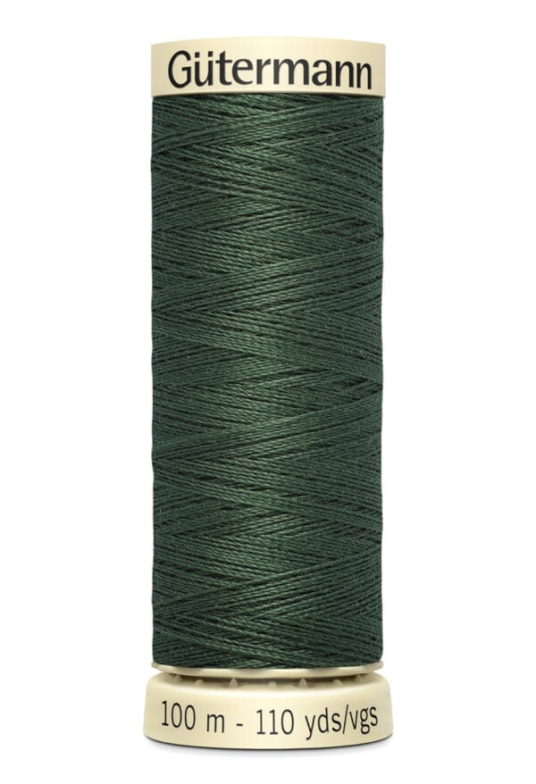 A spool of Gütermann thread with dark green color, labeled "100 m - 110 yds/vgs" at the bottom. The spool has a beige top and bottom, with the brand name "Gütermann" printed on the top section.