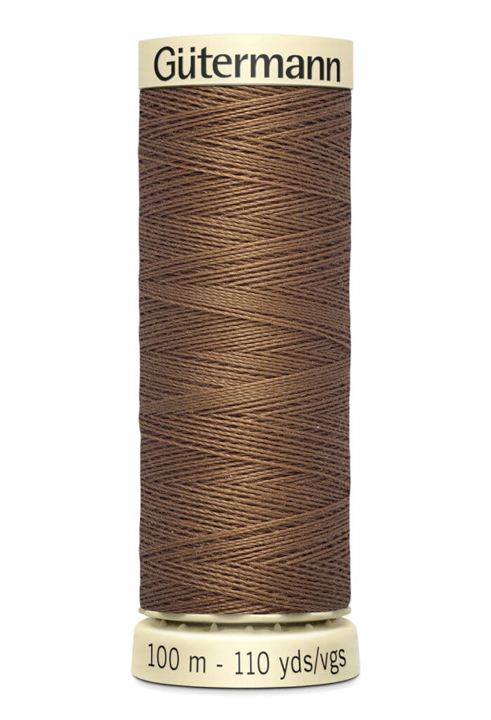 A spool of Gütermann thread in a brown color. The label indicates it is 100 meters or 110 yards long.
