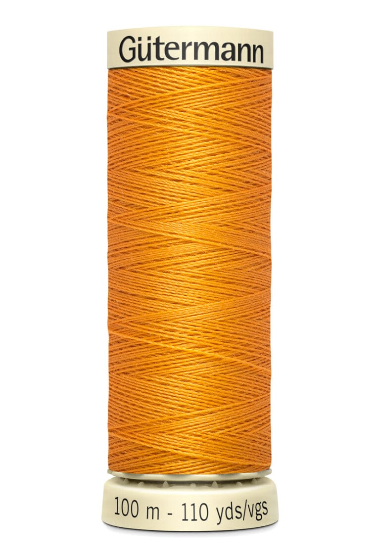 A spool of Gütermann thread in a bright orange color, labeled with measurements of 100 meters and 110 yards. The spool has a cream-colored top and bottom with black text.