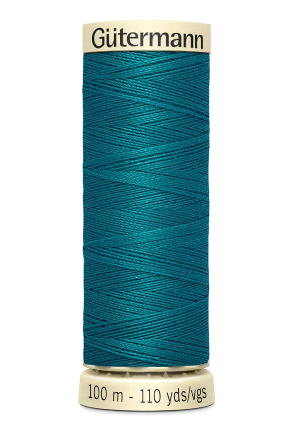 A spool of Gütermann thread in teal, with labels indicating 100 meters and 110 yards. The spool is cylindrical, with the brand name displayed at the top and the length details at the bottom.