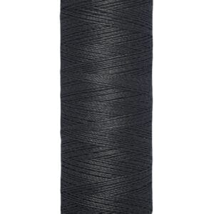 Spool of Gutermann black sewing thread, featuring a cream-colored top and bottom labeled with "Gutermann" and "100 m - 110 yds/vgs." The thread is tightly wound around the spool.