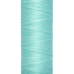 A spool of turquoise Gütermann sewing thread, with labels indicating 100 meters and 110 yards. The spool is cream-colored on top and bottom.
