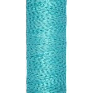 A spool of Gütermann thread with a turquoise color. The label indicates 100 meters or 110 yards. The spool is cylindrical with a beige base and top.