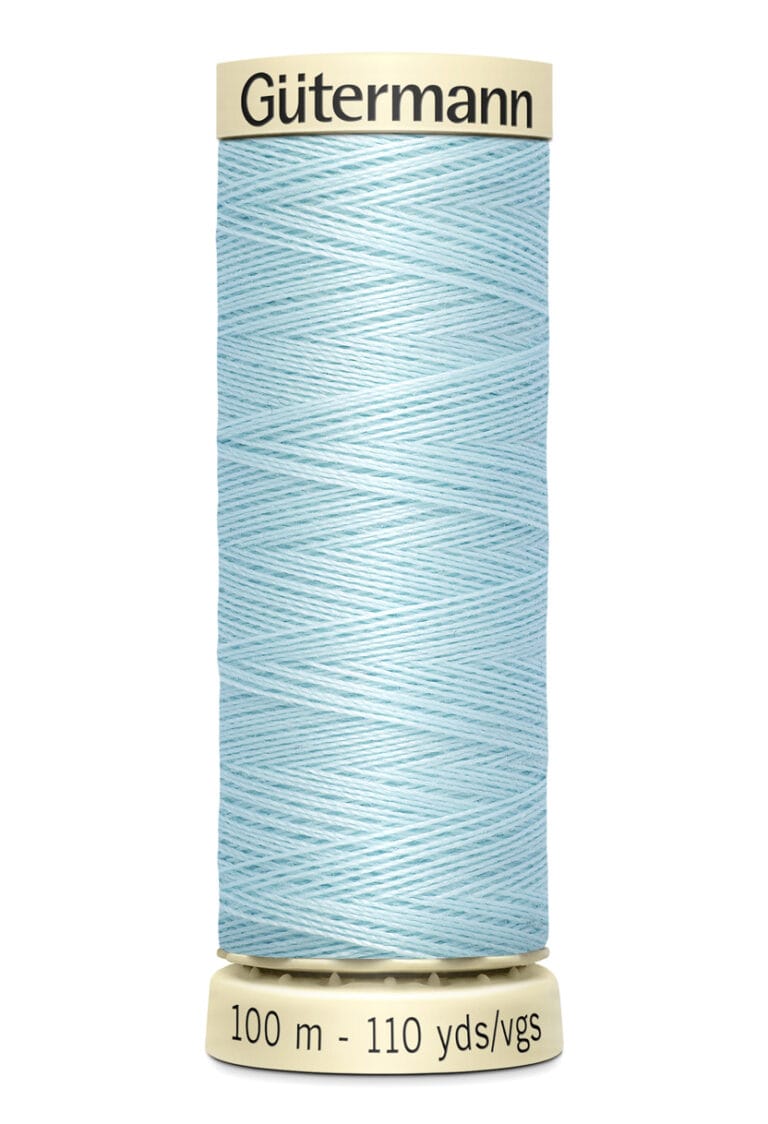 Spool of Gütermann light blue sewing thread, with 100 meters or 110 yards length, on a beige plastic base.