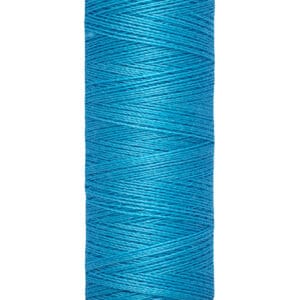 A spool of Gütermann thread in bright blue, labeled with "100 m - 110 yds/vgs" on the light-colored top and base. The thread is neatly wound in distinct layers, showing its texture and vibrancy.