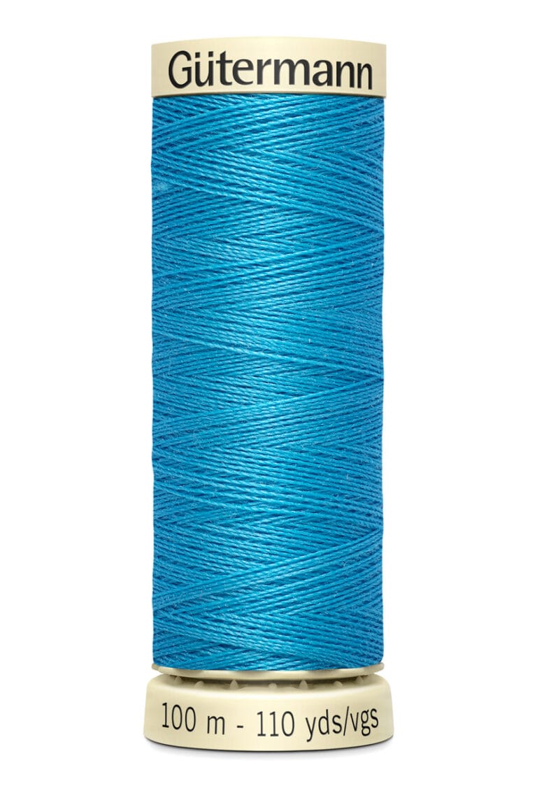 A spool of Gütermann thread in bright blue, labeled with "100 m - 110 yds/vgs" on the light-colored top and base. The thread is neatly wound in distinct layers, showing its texture and vibrancy.