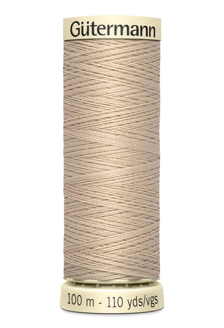 A spool of Gutermann thread in a beige color, with labeling that reads "100 m - 110 yds/vgs" on the base. The thread is wound neatly around a cream-colored cylindrical holder.