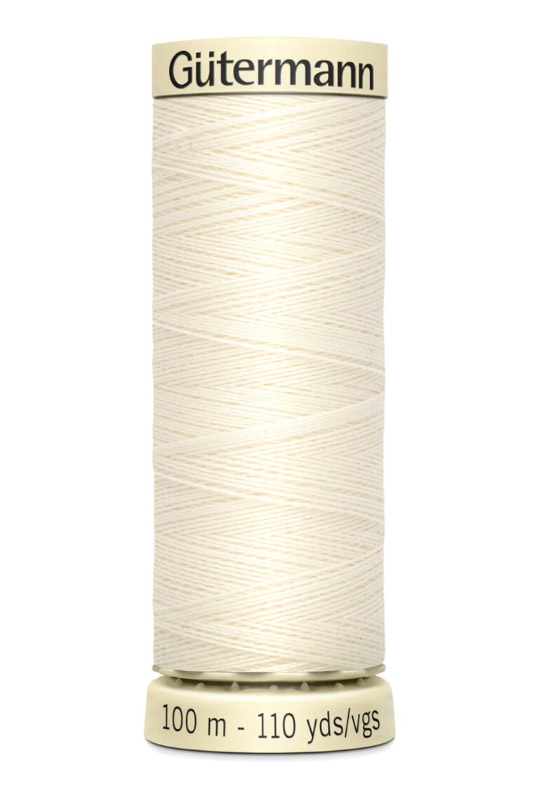 A spool of Gutermann thread with off-white color, labeled as 100 meters or 110 yards. The thread is neatly wound around a cylindrical spool with beige ends, displaying the brand name and length in both metric and imperial units.