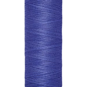 A spool of Gütermann thread in royal blue, showing its tightly wound texture. The spool's label reads "100 m - 110 yds/vgs" in black text on a light beige base and top.