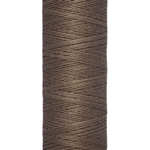 A spool of Gütermann sewing thread, brown in color, with a label indicating 100 meters or 110 yards.
