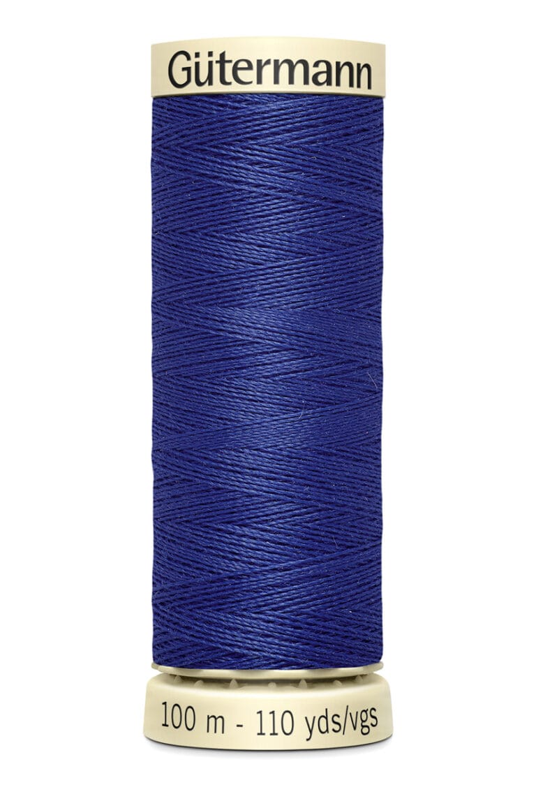 A spool of Gütermann blue sewing thread is shown. The spool is cylindrical and beige, with the brand name at the top. It holds 100 meters or 110 yards of thread.