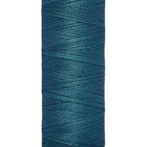 A spool of Gütermann sewing thread, 100 meters (110 yards) long, in a deep teal color. The spool is cream-colored, and the brand name is printed on the top edge.