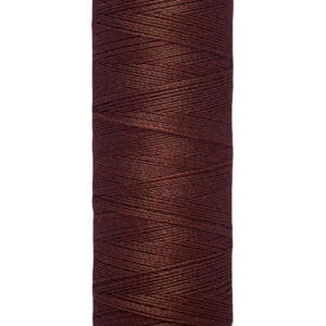 A spool of Gütermann thread, brown in color, with a label at the top. The spool contains 100 meters or 110 yards of thread.