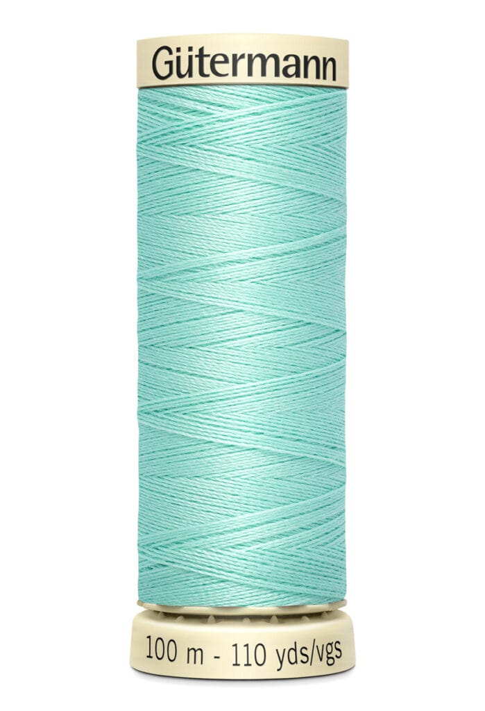 A spool of Gütermann sewing thread in a pastel mint color. The spool is labeled with "100 m - 110 yds/vgs" at the bottom, indicating the length of the thread.