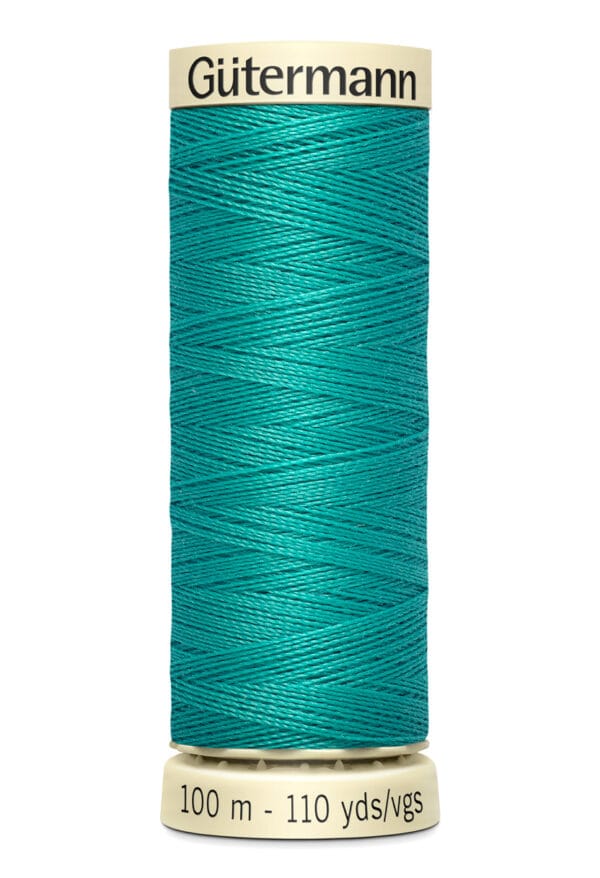 A spool of Gütermann thread, featuring a rich teal color. The spool is labeled with a length of 100 meters (110 yards).